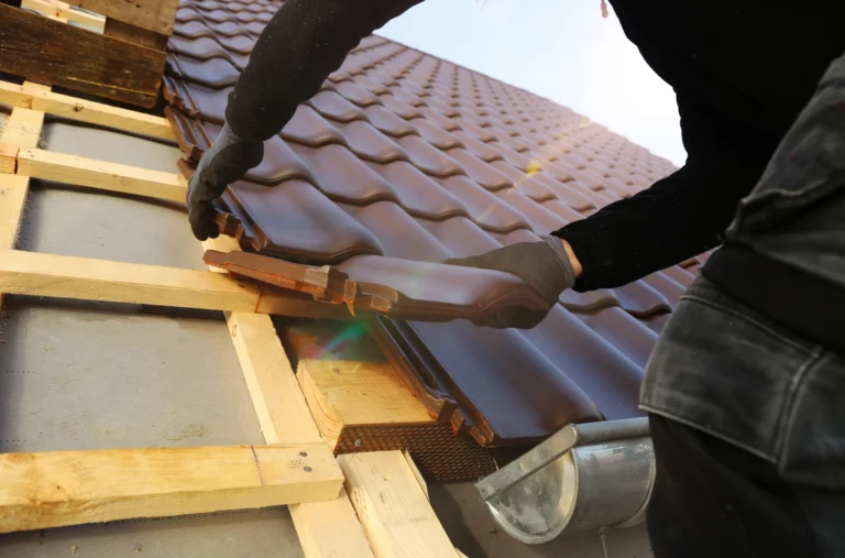 Image of a San Carlos Roofer installing barrel tiles on a home in Southwest, Florida